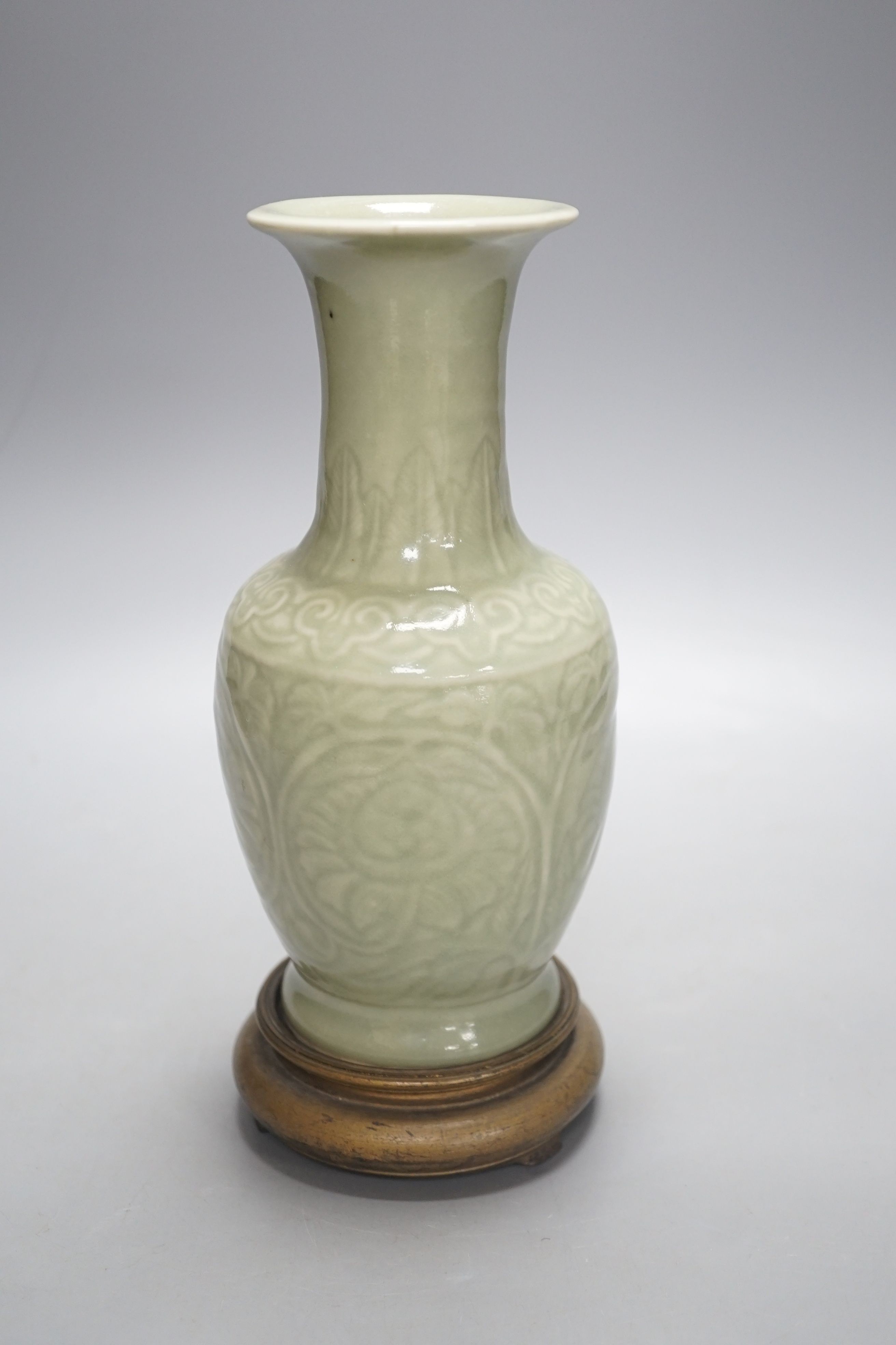 A Chinese celadon vase on stand, 24 cms high including stand.
